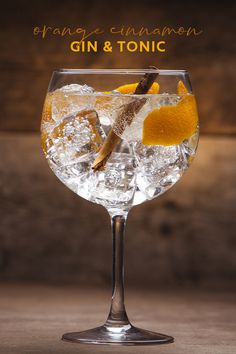 a gin and tonic cocktail with an orange garnish