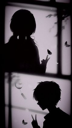 the silhouette of a person standing in front of a window with butterflies flying around them