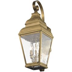 an old fashioned brass finish outdoor wall light with clear glass panels on the front and sides