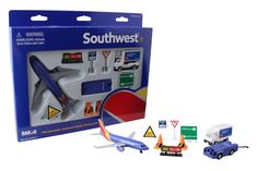 a toy airplane and some traffic signs on a white background with a blue box behind it