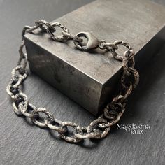 Sterling silver bracelet with oval, textured links, cast using lost wax casting method from silver grain.  Chain is soldered, each link was handmade and is heavily textured for aged look. The chain is oxidised, polished and tumbled for shine. Bracelet in the photos is suitable for 18 cm wrist, total length is 20.5 cm,  Weight 16g ( weight will vary depending on the length). Links are 12mm x 8mm. Please choose your wrist circumference from a drop down window. Oxidized Metal Bracelet With Oval Links, Oxidized Metal Chain Bracelet With Oval Links, Metal Chain Bracelet With Oxidized Finish, Sterling Silver Oxidized Link Chain Bracelet, Wax Casting, Lost Wax Casting, Lost Wax, Sterling Silver Bracelet, Chain Link Bracelet