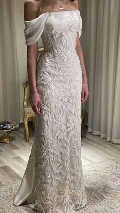 a woman in a white wedding dress posing for the camera