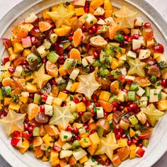 a white bowl filled with lots of fruit