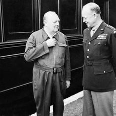 two men standing next to each other in front of a train