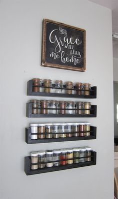 the spice rack is organized with spices and jars on it, along with a chalkboard that says once will lead me home