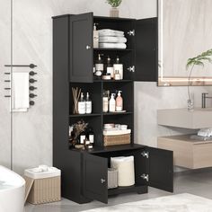 a bathroom with black cabinets and white towels