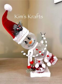 a snowman figurine with a santa hat on