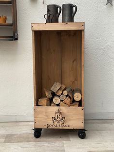 a wooden crate filled with firewood stacked on top of each other next to a wall