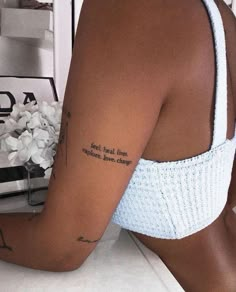 a woman with a tattoo on her left arm and the words for real love are written in cursive font