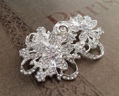 Rhinestone brooch, crystal brooch, wedding brooch, rhinestone brooch pin, crystal pin broochThis rhinestone brooch is  2 " long. (5 cm)Silver color metal base, clear crystals. Pin in the back. Nickel and lead free.This listing is for ONE brooch. You can add it to a hair-band, hair-clip, alligator clip, hair comb, sash, wedding ring bearer pillow, wedding bouquet, flowers... ===================SHIPPING========================Will be shipped within 2 business days via USPS First class mail with de Silver Crystal Brooches For Gift, Silver Crystal Brooches As Gift, Elegant Crystal Pins For Party, Elegant Silver Crystal Pins, Rhinestone Pins For Wedding, Crystal Brooch For Wedding Jewelry, Crystal Brooch For Wedding, Wedding Pins With Rhinestones, Silver Crystal Brooch Pin