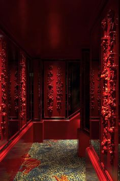 a hallway with red lighting and decorative columns