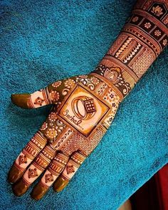 a hand that is decorated with henna and some designs on the top of it