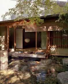 a japanese style house is surrounded by rocks and trees