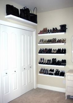 there are many pairs of shoes on the shelves in this room, all lined up against the wall