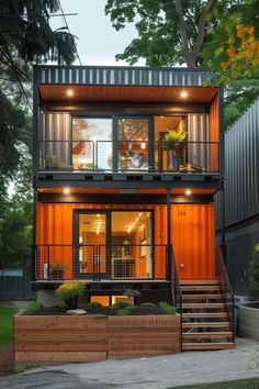 a house made out of shipping containers with stairs leading up to the second floor and windows