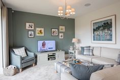 a living room filled with furniture and a flat screen tv