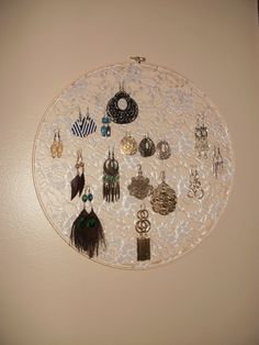 a white wall hanging with earrings on it