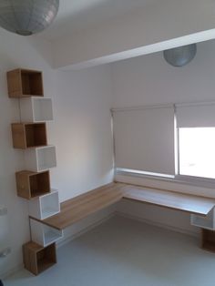 an empty room with some shelves on the wall