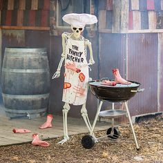 a skeleton grilling meat on top of a bbq in front of a barrel