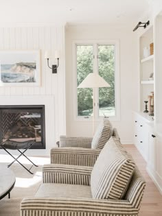 a living room filled with furniture and a fire place