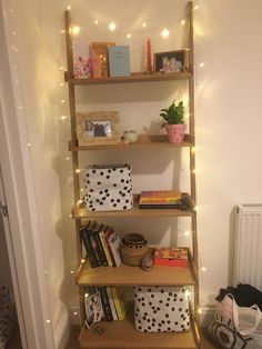 a book shelf filled with books next to a radiator