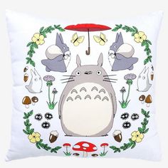 a pillow with totoro and other cartoon characters on it, all surrounded by mushrooms