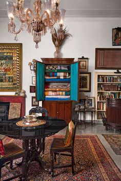 a living room filled with furniture and a chandelier