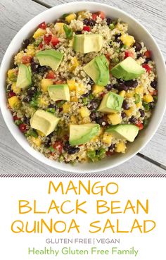 mango black bean quinoa salad in a white bowl with avocado on top