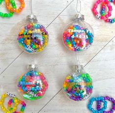 four ornaments with beads hanging from them on a wooden table next to the words tampa, florida and miami