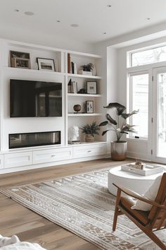 a living room filled with furniture and a flat screen tv on top of a wall