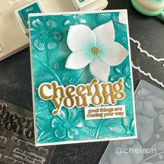 a close up of a card on a table with some scissors and other crafting supplies