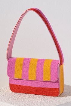 Everyday outfits just got more elegant with Shiraleah's Taylor Shoulder Bag. With its classic baguette silhouette, the purse's exterior is composed entirely of carefully embroidered glass beads. Its vibrant pink, orange, and yellow stripe design will give every outfit an extra pop of color. Pair with other items from Shiraleah to complete your look! Pink Purse Outfit, Beaded Shoulder Bag, Statement Purse, Purse Outfit, Purse Trends, Shoulder Bag Pink, Colorful Handbags, Buy Bags, Statement Bag