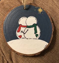 a wooden ornament with a snowman on it