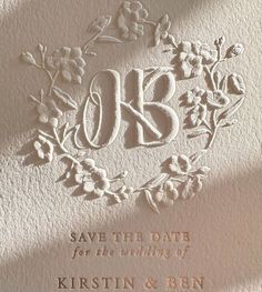 a wedding card with the initials and flowers on it