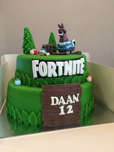 a cake that is decorated to look like a fortnite scene with an animal on top