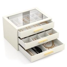 two white drawers with jewelry in them