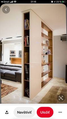 an open book shelf in the middle of a living room