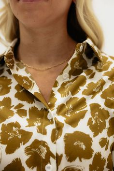 THIS SALE ITEM IS FINAL SALE! Experience effortless style with our Rowen Top-Golden Floral! This relaxed fit top features a button down design, collared neckline, and button cuffs for added versatility. The stunning floral pattern adds a touch of femininity to any outfit. Elevate your wardrobe with this must-have piece.(One model has collar tucked in) *Relaxed fit* Material Content: 100% Polyester Material Pattern: Floral Reagan is 5’5” wearing a small Model Measurements: Reagan Height: 5'5" // Pattern Floral, Model Measurements, Workout Tops, Polyester Material, Boutique Clothing, Effortless Style, Trendy Outfits, Final Sale, Floral Pattern