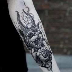 a person with a tattoo on their arm and an animal in the middle of his arm