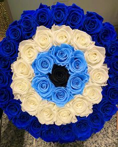 a large blue and white rose bouquet on a table