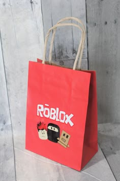 a red paper bag with roblox on it