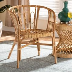 a wicker chair next to a table with a vase on it