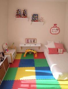 a child's bedroom with multicolored flooring and toys on the walls