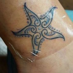 a tattoo on the leg of a woman with a cross design on her left side