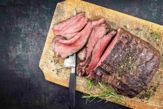 a piece of steak on a cutting board with a knife