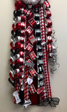 a christmas tree made out of cans and tinsels is hanging on the wall