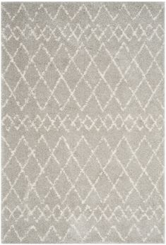 a gray rug with white designs on it and a light colored background in the middle