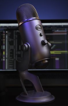 a purple microphone on a stand in front of a computer screen