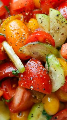 a salad with tomatoes, cucumbers and other vegetables