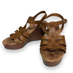 Style Name: Pleasing Color: Cognac Shoe Type: Wedge Platform: Yes Heel Height: 4” Condition: New, Unused Materials: Manmade Closure: Buckle Inner Sole: Memory Foam Made In China Brown Wedge Sandals With Removable Insole, Casual Brown Wedge Sandals With Round Toe, Brown Platform Wedge Sandals With Round Toe, Brown Wedge Sandals With Heel Loop And Round Toe, Casual Closed Toe Wedge Sandals With Heel Loop, Brown Synthetic Platform Wedge Sandals, Brown Platform Wedge Sandals In Synthetic, Brown Platform Wedge Sandals In Synthetic Material, Casual Wedge Sandals With Removable Insole